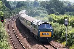Western Champion painted in chromatic blue, hauling a passenger train