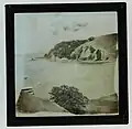 Wraggle, C. Photograph taken from a hill overlooking a bay.