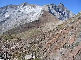 A building from far and above shown on a plateau between two mountain features