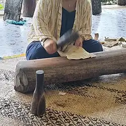 Beating the bark over an anvil