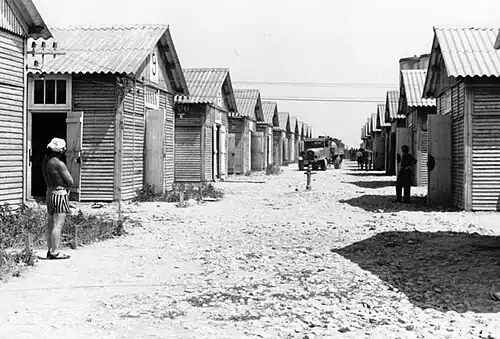 Main street of the camp with barracks and prisoners[note 1]