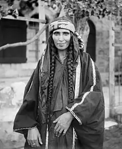 Image 9A Bedouin woman in Jerusalem, sometime between 1898 and 1914, dressed in Palestinian costume, the traditional clothing worn by Palestinians. Many of the handcrafted garments were richly embroidered and the creation and maintenance of these items played a significant role in the lives of the region's women. Until the 1940s, traditional Palestinian costumes reflected a woman's economic status, whether married or single, and the town or district of origin, and a knowledgeable observer could glean such information from the fabric, colors, cut, and embroidery motifs (or lack thereof) in a given woman's apparel.