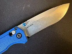 Open Benchmade folding knife with blue G10 handles and an uncoated blade marked S30V