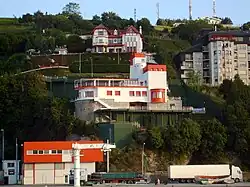 Modern house among others on the side of a hill