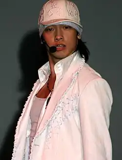 An image of Rain wearing an all-white outfit during a performance.