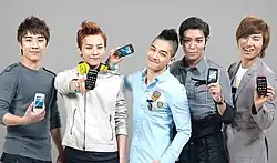 BigBang smiling for the camera while holding LG cellphones