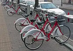 A rack of red-and-white bicycles, locked into place