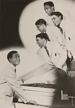 The Dominoes in 1952 (Top to Bottom): Joe Lamont, David McNeil, James Van Loan, and Clyde McPhatter. (Standing at Piano): Billy Ward.
