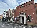 23–33 Market Place, on the southern side of Blackpool Old Road