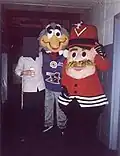 Blitz (centre), former mascot of the Alouettes, poses for a photo with former Drummondville Voltigeurs mascot Boum-Boum (right) and an unnamed man (left) at Centre Marcel Dionne in April 2002.