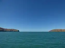 Godley Head (left) and Te Piaka / Adderley Head (right), as seen from Lyttelton Harbour / Whakaraupō