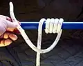 Make 5 turns around the object at opposite side of to the pull direction of the standing part, then cross the standing part to the pull direction and make one more turn