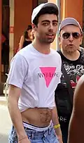 A man wearing an improvised crop top