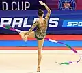 Holding the ribbon handle with a foot during a rotational element (Boryana Kaleyn)