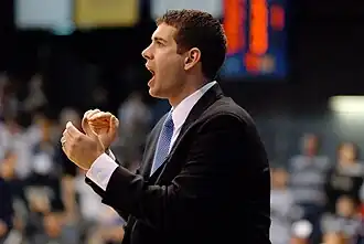 Stevens with his mouth open to shout, and his hands clapping.