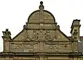 A dutch gable displays the Coat of arms of Leeds and the words 'PUBLIC BATHS'[2]