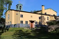 Photograph of the outside of a large yellow building