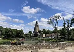 View of Brezolles, with the church in the background and lake in the foreground.
