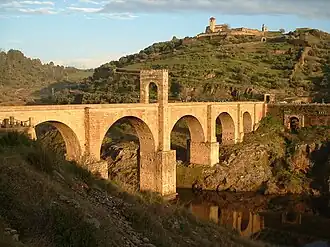 A stone arch bridge passing over a valley