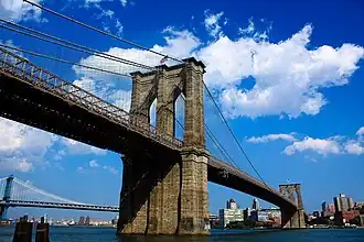 A large suspension bridge, with large towers made of stone