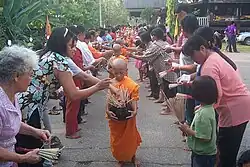 Image 78Buddhist novices receiving joss sticks. (from Culture of Thailand)