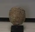 Clay bulla that sealed the bonds of a bundle, with the impression of the seal of Naram-ili, an official during the reign of Shulgi. Louvre Museum.