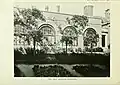 Sepia photograph of the outside of building with four arched windows