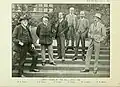 Sepia photograph of six gentlemen standing outside on pathway stairs