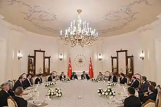 The Presidential emblem behind President Gül (2013)