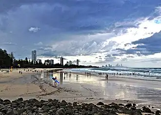A beach in Burleigh Heads with high rise developments further in the background