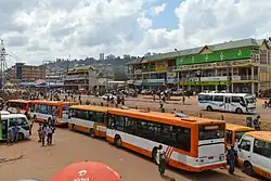 Photograph of bus station, including vehicles and buildings