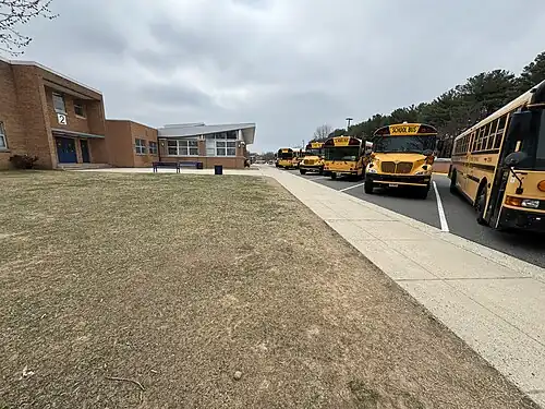 School buses lined up in front of the school