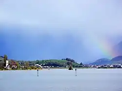 Obersee as seen from the wooden bridge between Rapperswil and Hurden towards the village of Busskirch and the Buechberg hill