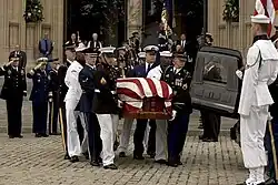 Honor guards carry the casket of former President Ronald Reagan to a waiting hearse outside of Washington National Cathedral.