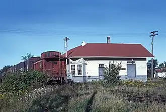 A Chicago and North Western freight train passes Stiles Junction heading to Oconto Falls. September, 1964.