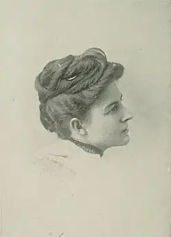 19th-century B&W portrait photo of a woman with her hair in an up-do, wearing a dark, fitted blouse.