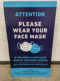 Photo of a sign saying "ATTENTION PLEASE WEAR YOUR FACE MASK"