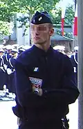 A CRS police officer in normal gear, including a bonnet de police.