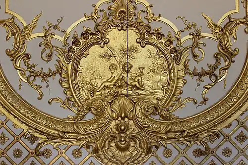 Rococo cartouche with putti in the Cabinet de la Pendule, Palace of Versailles, France, created and sculpted by Jacques Verberckt, 1738[16]