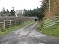 Gate and track leading to Cairn's Mill, southern end of the steadings visible