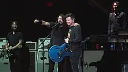 Rick Astley on stage with the Foo Fighters