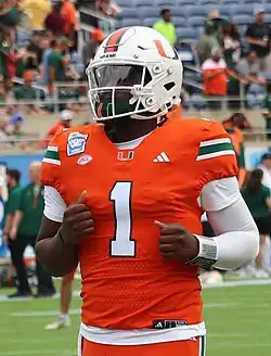 A photo of Cam Ward in a University of Miami jersey. He appears to be mid run.