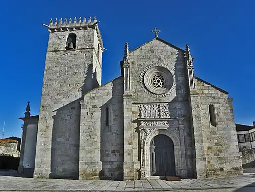 Church of Caminha (15th/16th centuries). Its Gothic and Manueline decorative motifs and Renaissance portal are flanked by a heavy Romanesque-like bell tower.