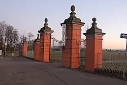 Entrance gate to the tree-lined avenue of Villa Pallavicini