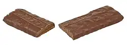 A Skor candy bar broken in half.