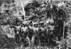 Eight soldiers standing in a jungle