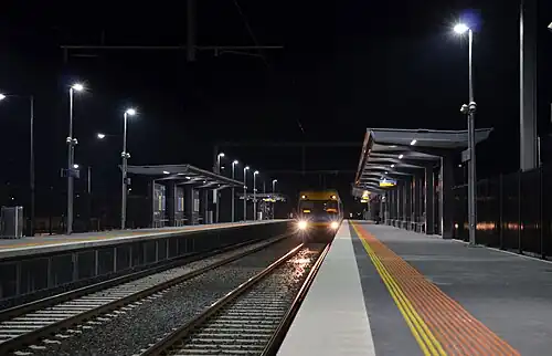 A train arriving at the new illuminated platforms at Cardinia Road station in the early morning