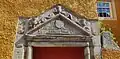 Carved stone lintel with IT and BT initials, above front door (1617).