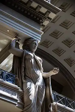 A caryatid in the three-story area of the mall