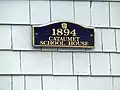 Plaque alongside front entry door.